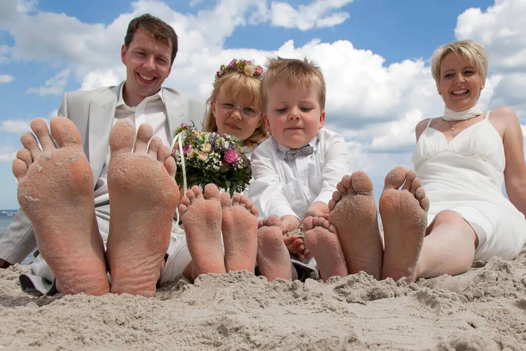 Hochzeitspaar mit Kindern am Strand auf Rügen